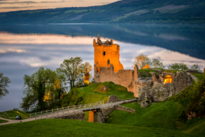 A castle with a bridge over it's side.